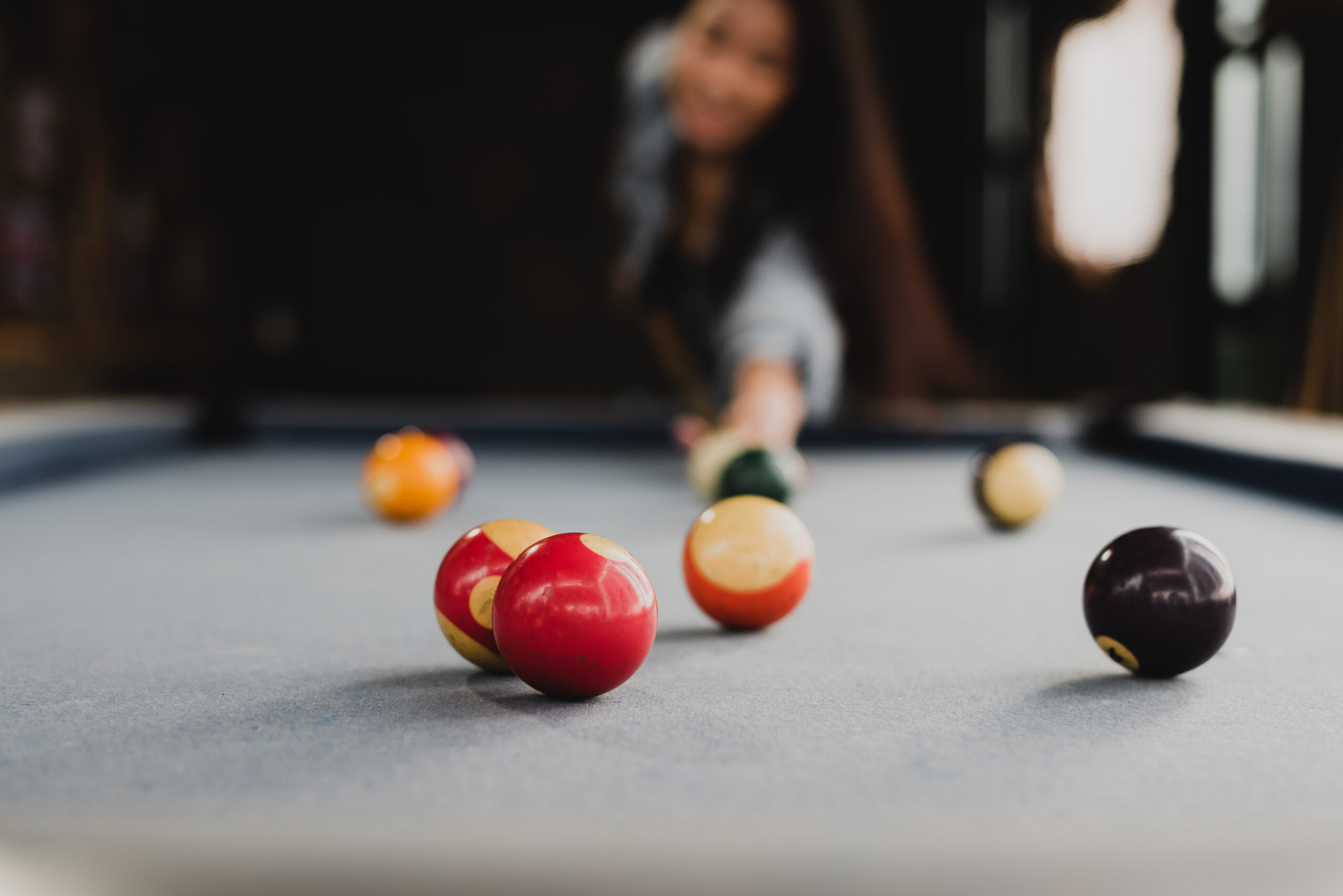 a woman playing billiards