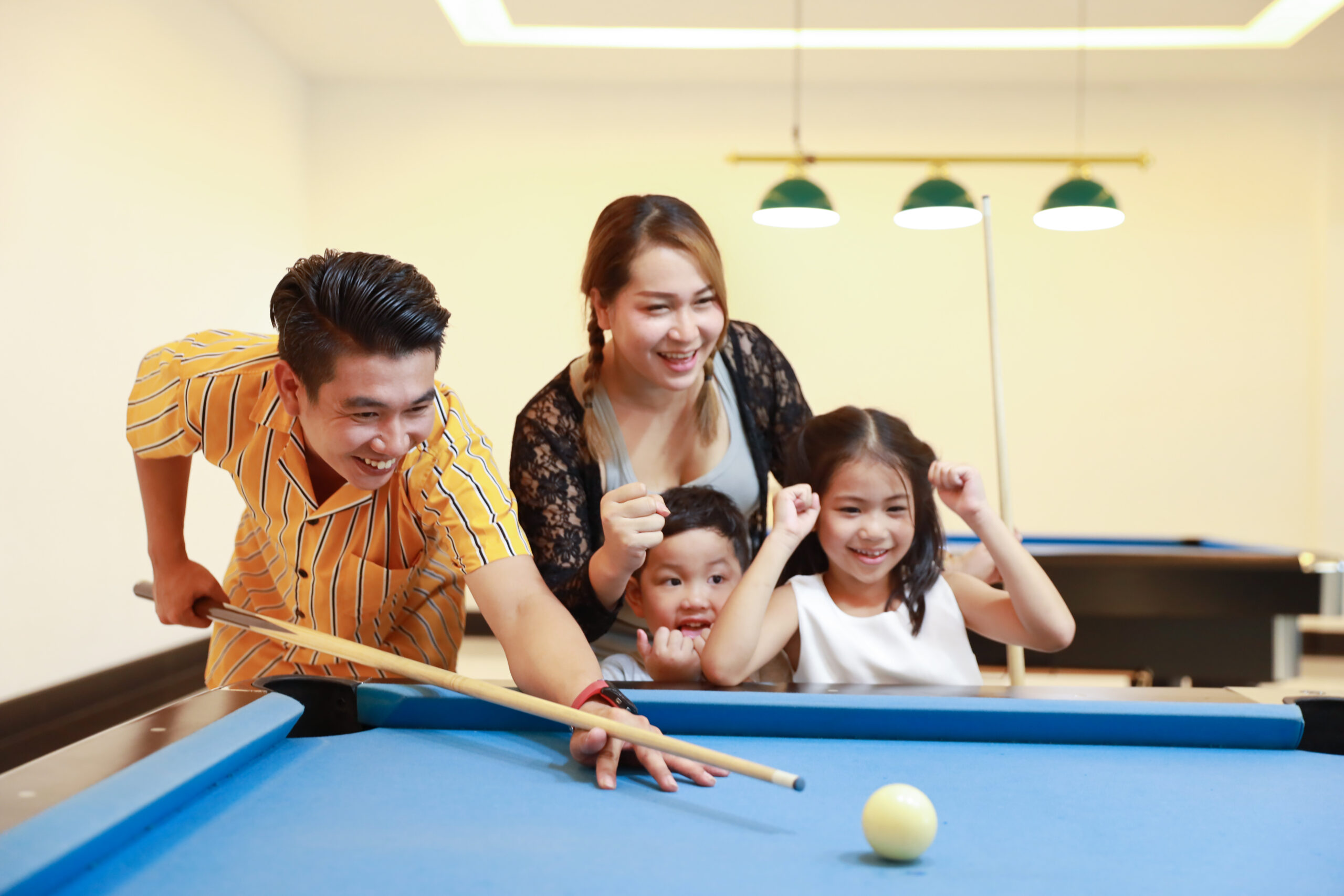 a family playing billiards