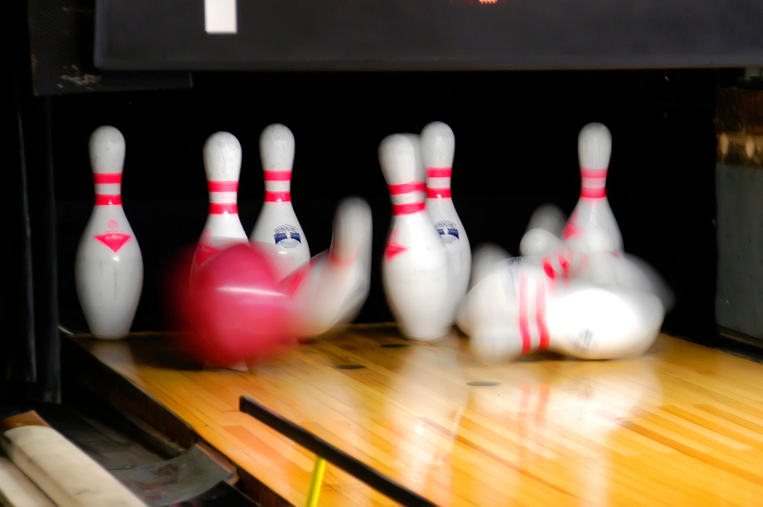 bowling pins about to be hit by a ball