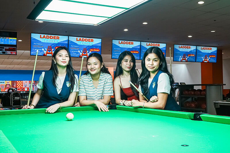 women playing billiards